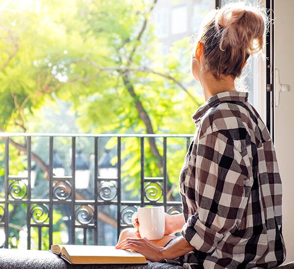 Young,Pretty,Woman,Sitting,At,Opened,Window,Drinking,Coffee,And